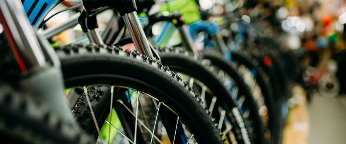 bicycle-shop-rows-of-new-bikes-cycle-sport-store-PWHBJZ7