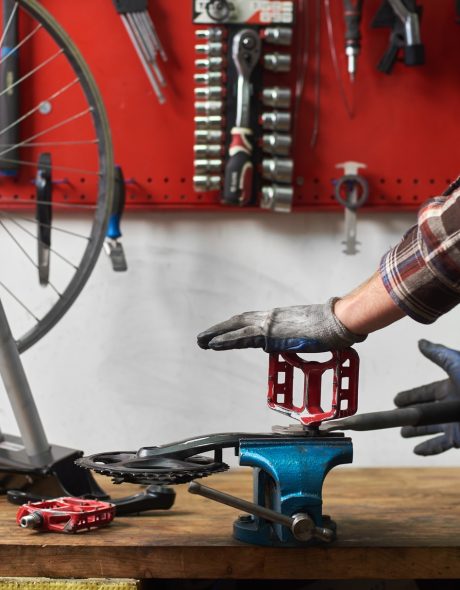 male-mechanic-working-in-bicycle-repair-shop-using-MY838FC